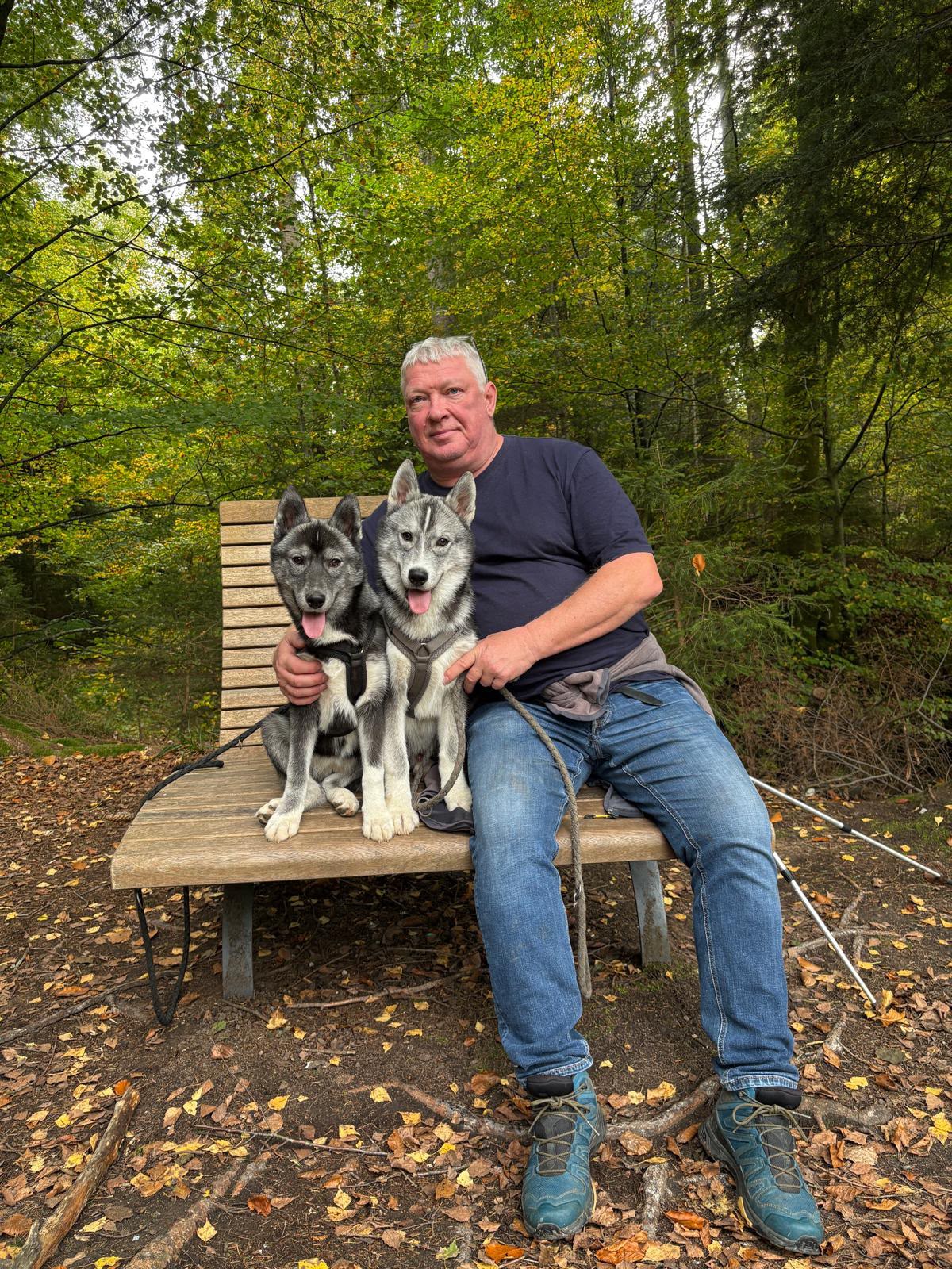 Sven, Mitarbeiter bei Pudelwohl365, mit seinen zwei Hunden im Wald